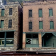 To the left is the The Goodman-Kincaid Building, which housed stores and two floors of apartments until residents moved out in 1959 when the roof started to collapse.