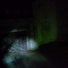A fireplace in the dark - perhaps Josephine's chamber?